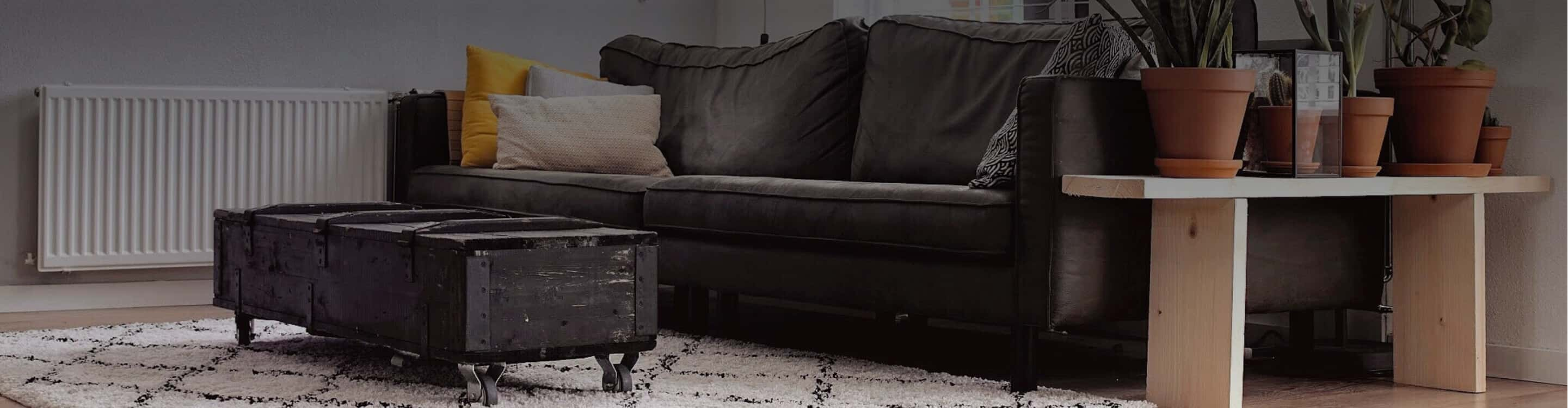 causal living room with, wood-look vinyl floors, textured rug and relaxed gray sofa