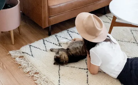 Woman with cat on area rug
